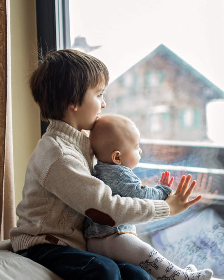 Two children looking out the window